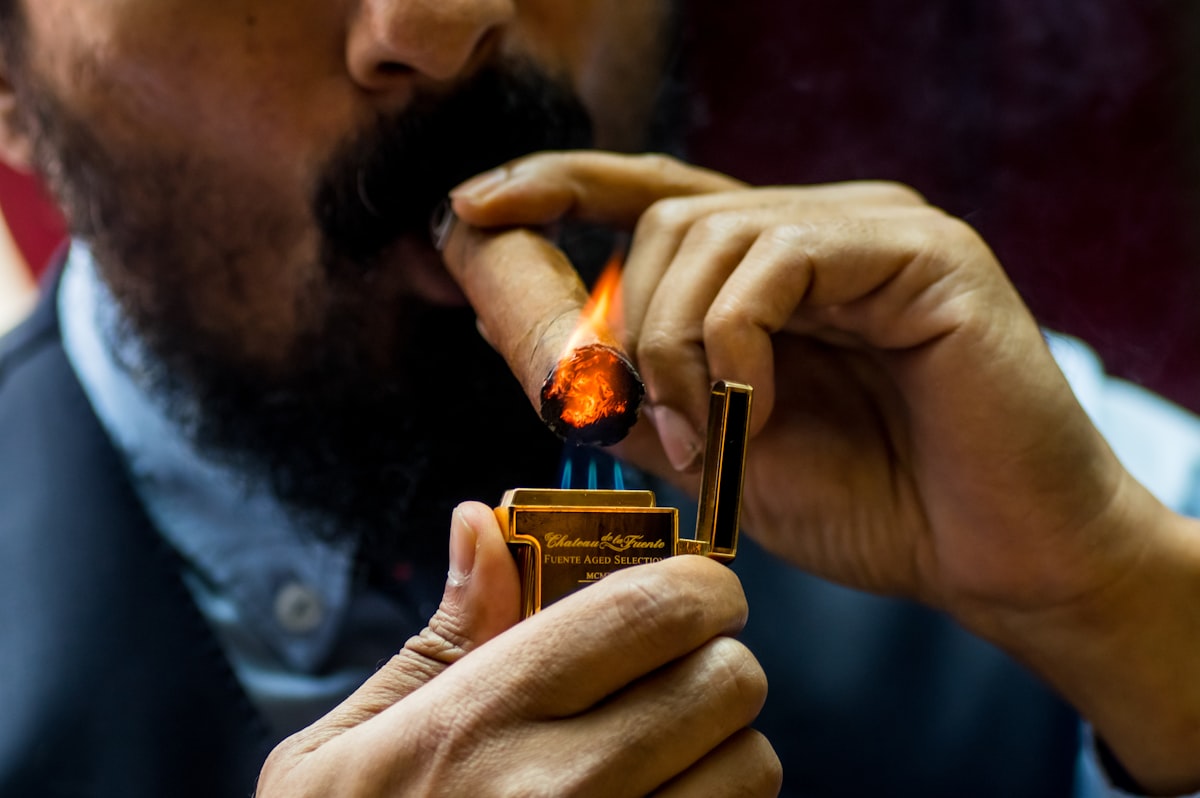 Man lighting a cigar at an event